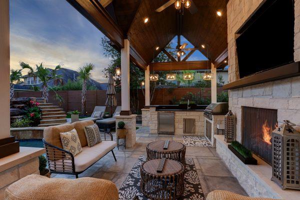 Expanded outdoor living with a fireplace and outdoor kitchen