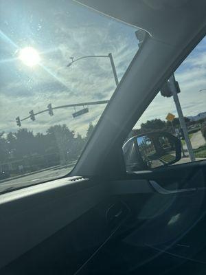 The dirt film still on the windshield after a $16 car wash.