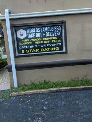 Easy to miss sign on the side of the vacant building. Place food orders and pickup in the back of the building.