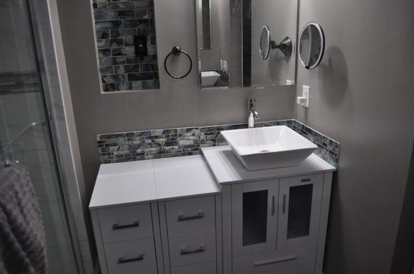 Enlarged master bath, installed vanity and tile flooring.