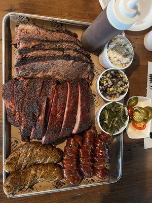 Brisket, Pork Ribs, Boudin, jalapeño cheddar Sausage, and sides.