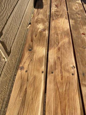 Roof to Deck - Second Deck Sanding done by RTD (VickyLS review). The marks are deep scratches in the cedar wood deck.