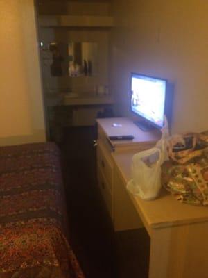 The TV and desk in front of bed