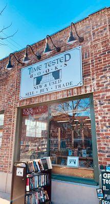 Street view of the front of the store. $1 book cart out front