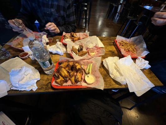 2 orders of wings , 2 burger platters, 2 orders Philly cheesesteak egg rolls, water & Meads, we 3 little piggies