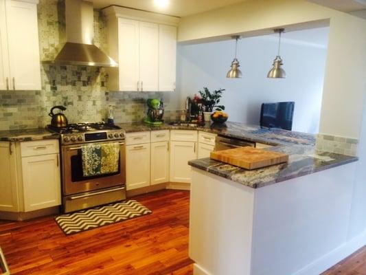 Granite - 3 pieces in this peninsula design (by the sink and by the column)