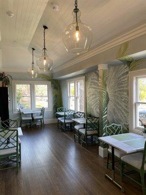 Beautiful dining room with a gorgeous hand-painted peacock and palm leaf mural