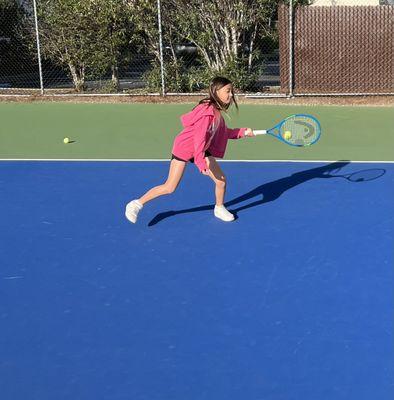 Kara reaching for the ball on her forehand