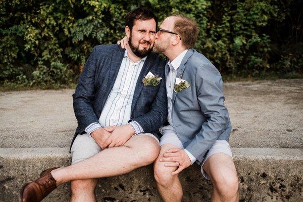 Two grooms on their wedding day at the Seattle Arboretum.