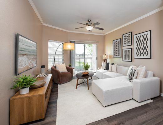 Living room with ceiling fan at Crescent Cove at Lakepointe