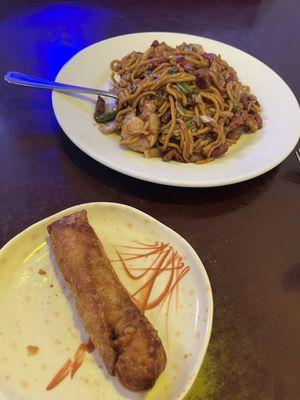 Combination lo mein and egg rolls.