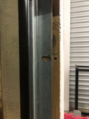 Detached screws from the door track to enter our "secure" storage unit.