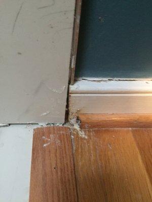 The wood floor tile was mis-cut, but it was termed "squaring".  Vertical tile did not match up with the base trim and was filled with caulk.