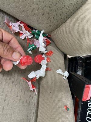 Candies taken out of a cup that was in the console and chewed. Tiny pieces of the wrappers scattered everywhere