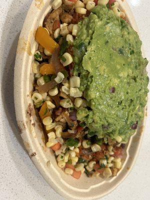 Burrito bowl with brown rice, black beans, corn, guac, hot salsa, fajita veggies