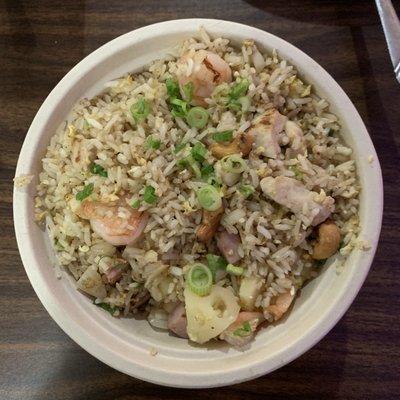 Perfect combo of shrimp, ham, chicken, cashews, and pineapples in the Pineapple Fried Rice.