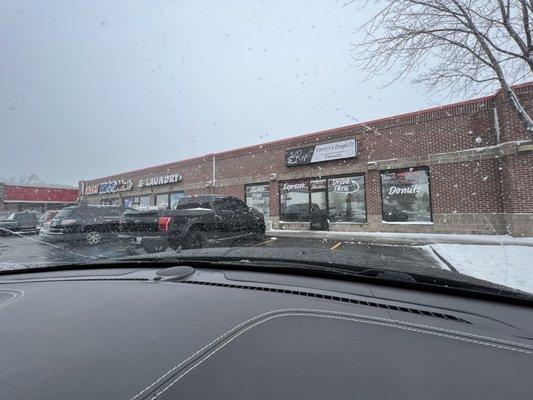 Outside view, coffee/doughnut shop on the right