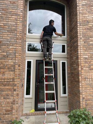 Giving the windows a final wipe down upon being installed.