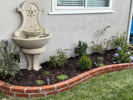 After installed fountain and brick edging.