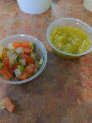 Salsa bar with salsas,  pico, cucumber, jalapeno, cilantro, onions, and limes