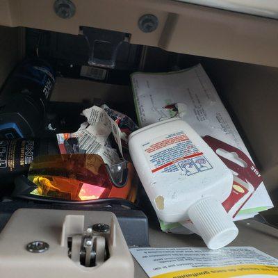 Chewed up paperwork and bottles in the glove Box by rat