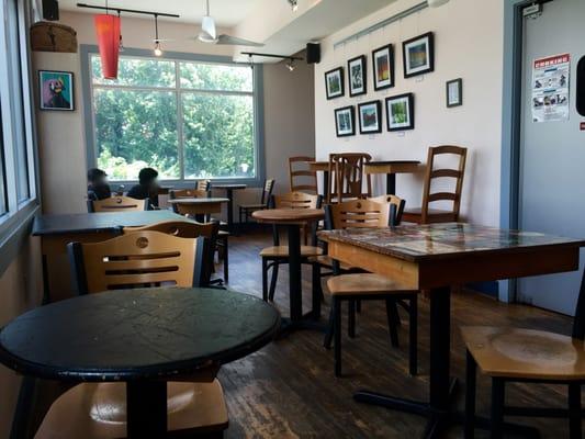 Some of the tables at JavaVino. There are a few more tables and bar seating against a window.