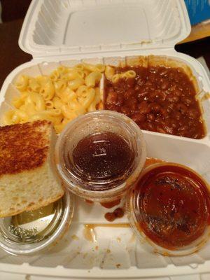 Mac n cheese, baked beans, corn bread, pickles, BBQ sauce & brisket sauce