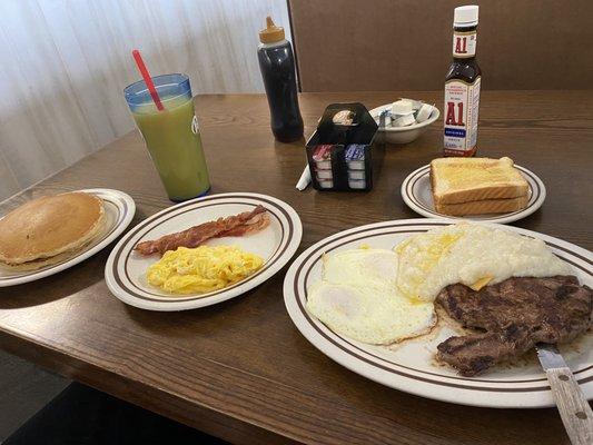 Left: pancakes, bacon, eggs. Right: steak and grits with eggs and toast. Orange juice.