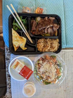 Bento Box with steak, fried rice, and crab rangoon and a Poke Bowl with spicy crab, tuna polk, and spring mix.