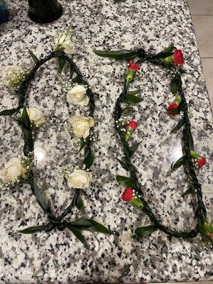 Ti-leaf lei using their baby's breath, mini red carnations, ti-leaf, and aspidistra.