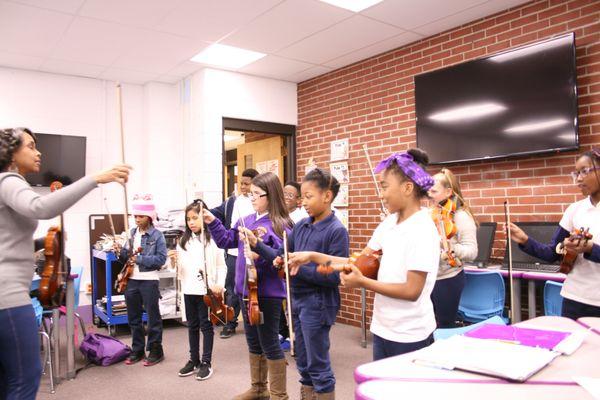 Grade 4 students reviewing bow hold through a game