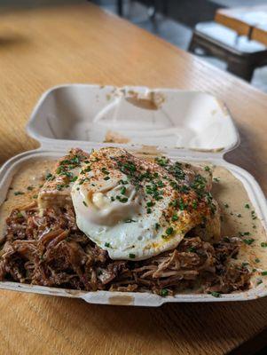 Biscuits and gravy with egg and pork confit.