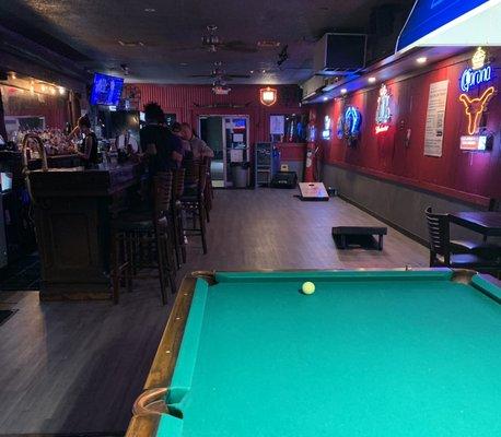 Pool tables, corn hole and a bar.