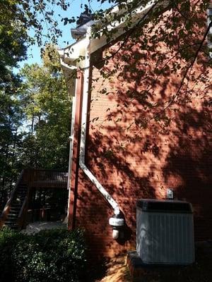 Exterior shot of a Radon Mitigation System installed by Georgia Radon Solutions resulting in reduced levels averaging 1.9pCi.