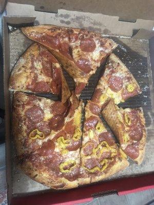 A very sloppy pizza that looks like it's been dropped