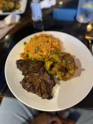 T-bone lamb with curry potatoes and jollof rice.