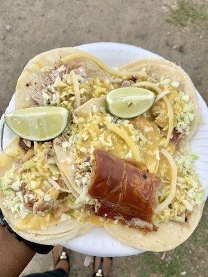 Suckling Pig Tacos topped w/ Cabbage, Onions, Mustard Salsa and Crispy Pig Skin.  Delicious!