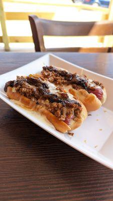 The decked out dogs, chili, queso, bacon, onion jam