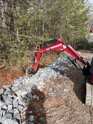 Installing rip rap  Driveway drainage repair.