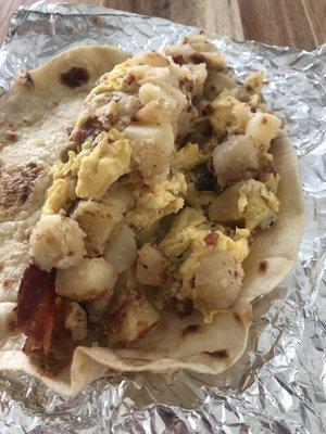 Ordered two bacon n egg tacos for Mrs. Texas. Added potatoes, and a strip of bacon for an up charge. She could only eat one.