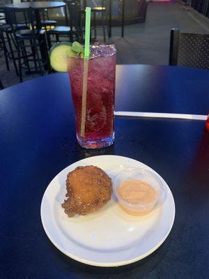 A Huckleberry Cucumber Mojito and a Hushpuppy with dip.