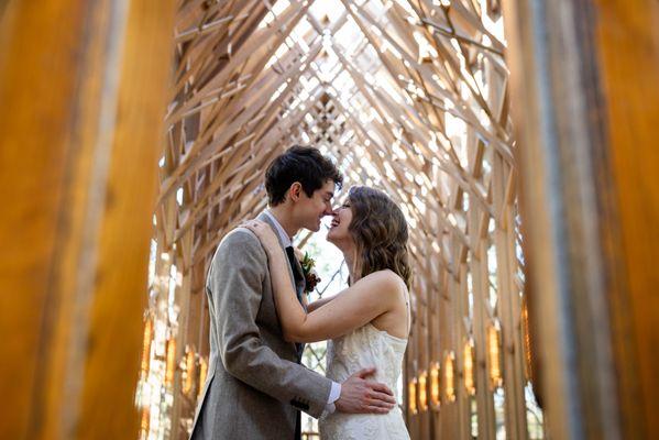 Intimate moment between bride and groom inside Anthony Chapel, Hot Springs, showcasing architectural beauty. Photo: Michele McCoy Photograph