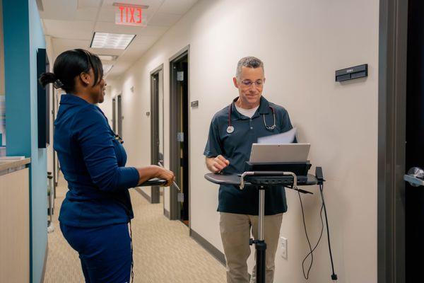 Dr. Norris reviews information with his nurse