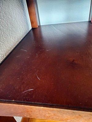 white dog fur on bed side table.