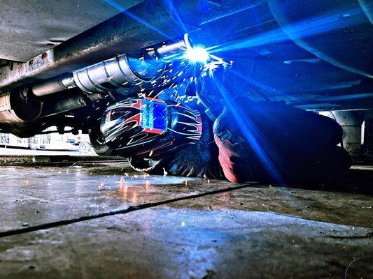 Welding a new catalytic converter onto a motorhome.