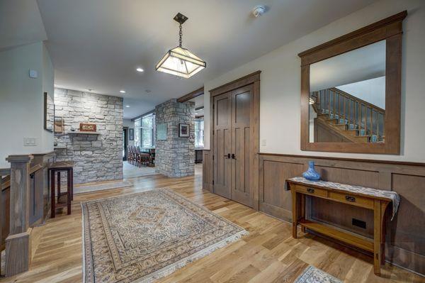 This stunning Arts and crafts foyer was carefully designed with custom millwork and the perfect lighting.