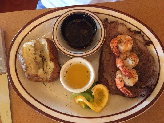 Prime rib with grilled shrimp and baked potato