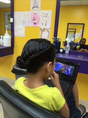 Tida love being able to watch a DVD while getting her hair treatment done.