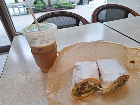 Iced latte and steak and cheese sandwich