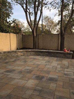 Patio pavers with seating wall for intended fire pit use